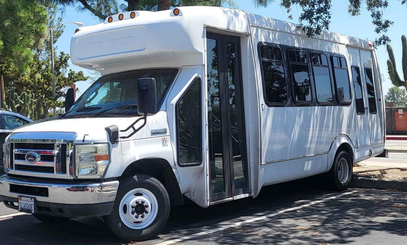 a white sagehen shuttle is parked in the mesa parking lot